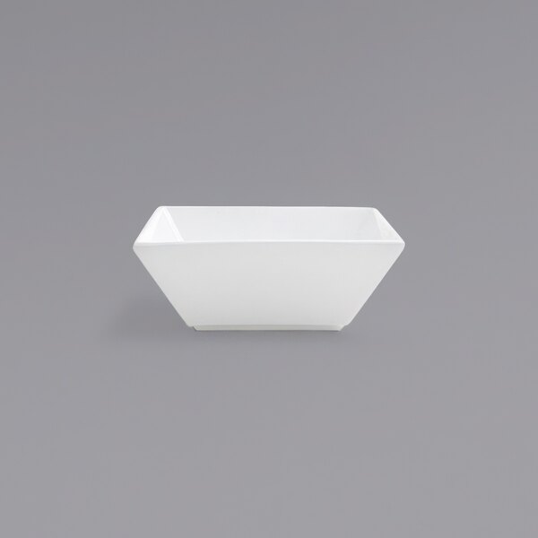 A Front of the House Kyoto bright white square porcelain bowl on a gray background.