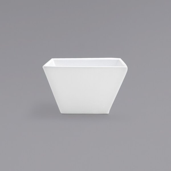 A Front of the House Kyoto bright white tall square porcelain bowl on a grey surface.