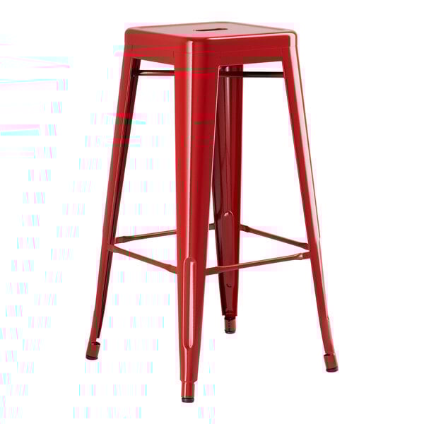 A Lancaster Table & Seating red metal backless barstool with legs.