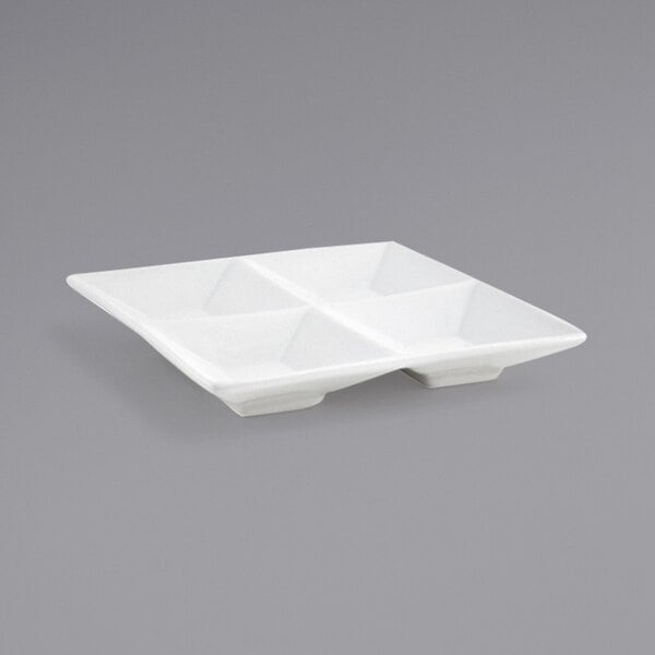 A white square porcelain dish with four compartments.