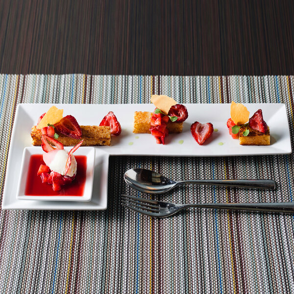 A Front of the House Kyoto porcelain plate with strawberries and dessert on it.