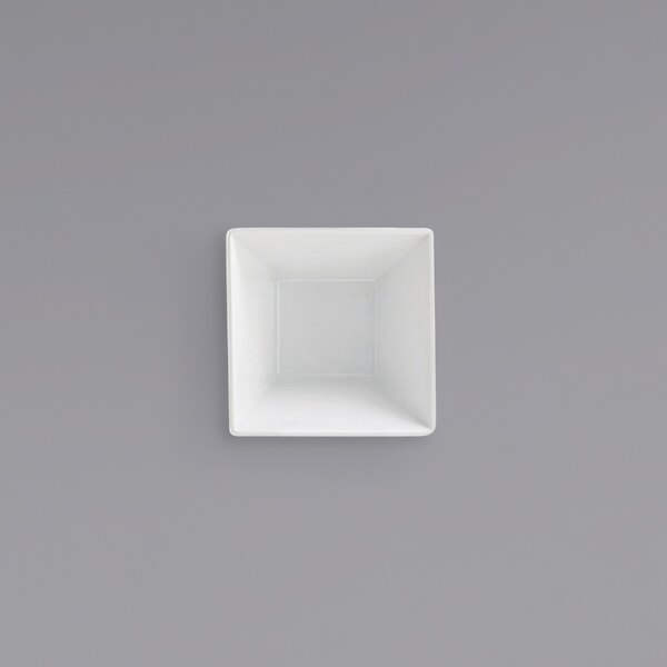 A Front of the House Kyoto bright white tall square porcelain bowl on a gray surface.