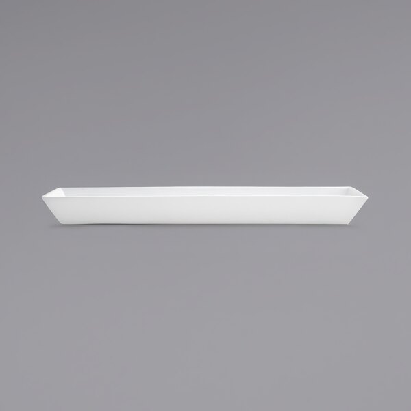 A white rectangular porcelain server with a long handle.