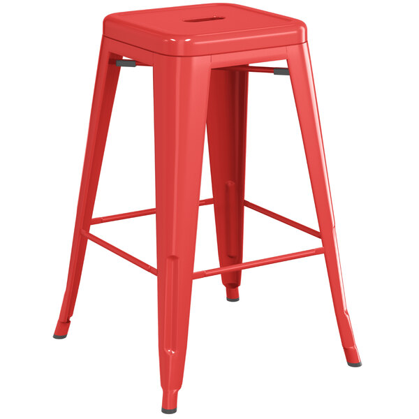 A Lancaster Table & Seating outdoor backless counter height stool with a red metal seat.