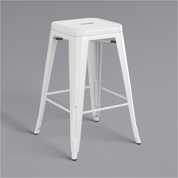 A white outdoor backless counter height stool with a metal base and a square seat.
