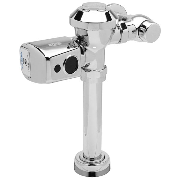 A close-up of a chrome metal Zurn urinal flush valve with a battery sensor.