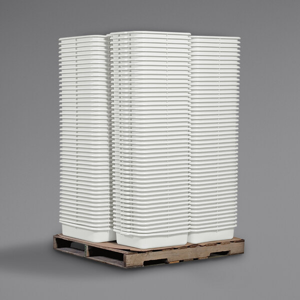 A stack of Tablecraft white bus tubs.