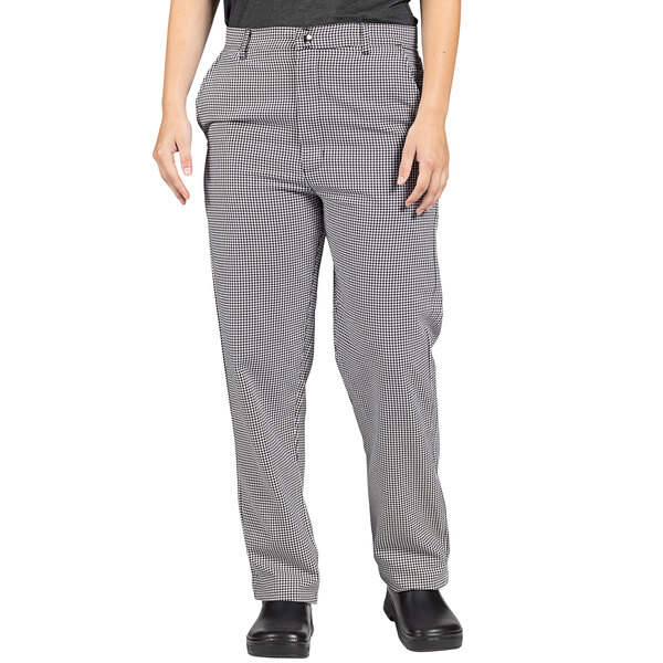 A woman wearing Uncommon Chef black and white checkered chef pants.