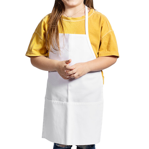 A young girl wearing a white apron.