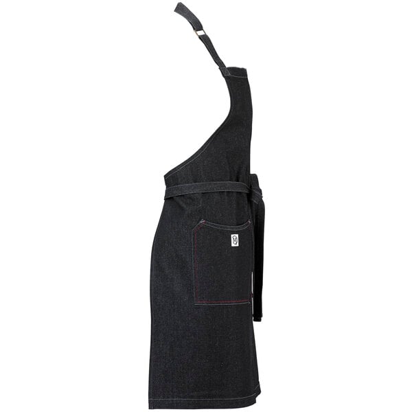 A close-up of a black Mercer Culinary denim bib apron with red stitching.