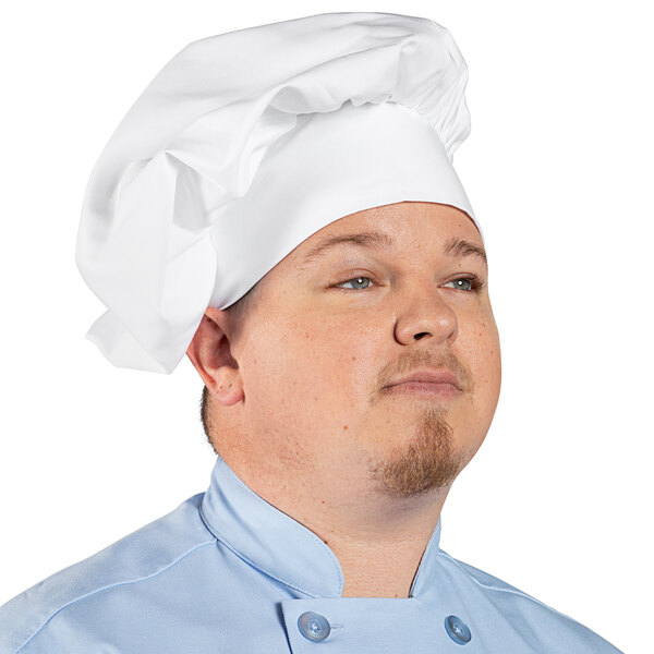 A man wearing a white Uncommon Chef poplin chef hat.