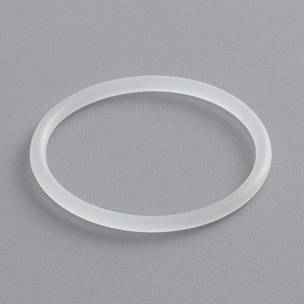 A white rubber ring on a gray surface.