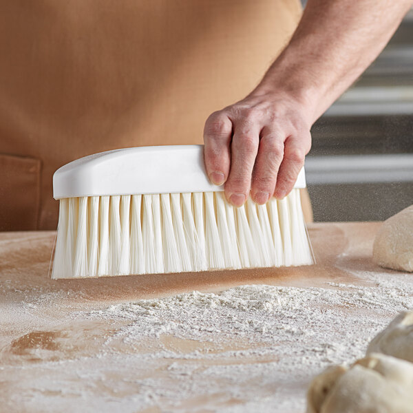 a close-up of a broom sweeping a surface