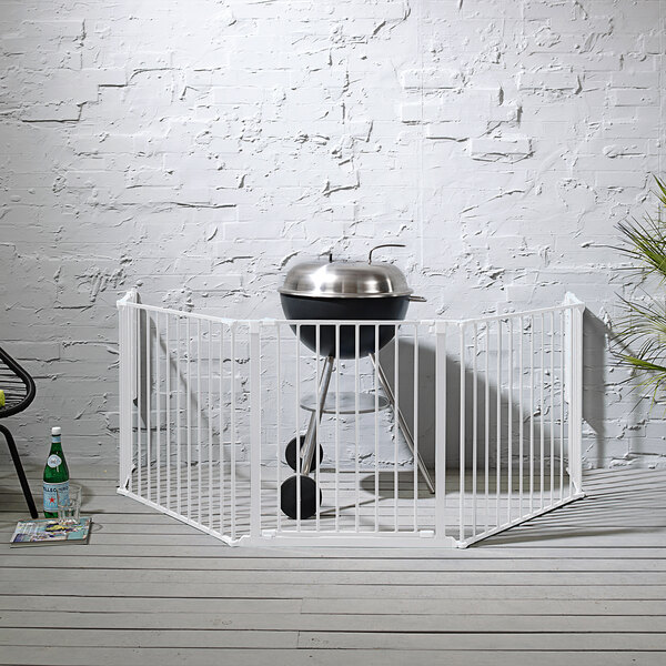 A white BabyDan Flex XL hearth safety gate set up on a patio.