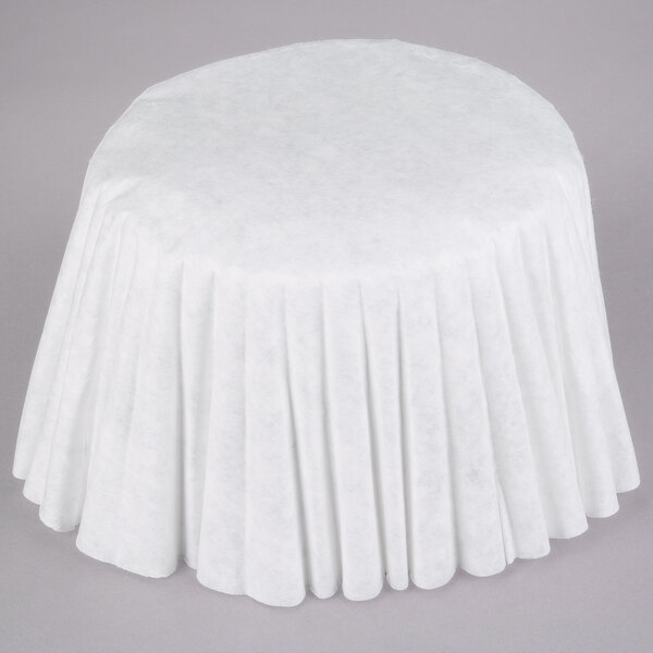 A white tablecloth with a pleated pattern on a table.