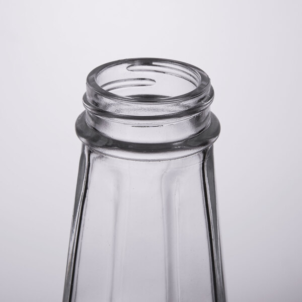 A clear glass Thunder Group Mushroom Top Paneled Salt and Pepper Shaker with a lid on top.