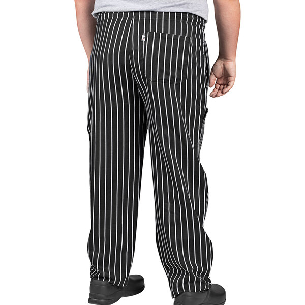 A person wearing Uncommon Chef black and white pinstripe cargo chef pants.