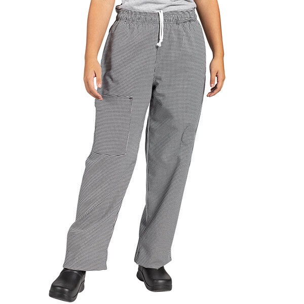 A person wearing Uncommon Chef black and white houndstooth cargo pants.