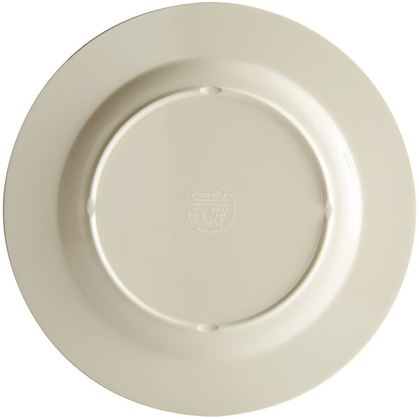 A close up of a Carlisle sweet cream melamine plate with a circular edge.