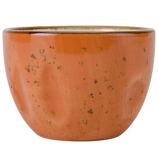 A Tuxton Artisan Geode Coral bouillon cup with a speckled design in orange.