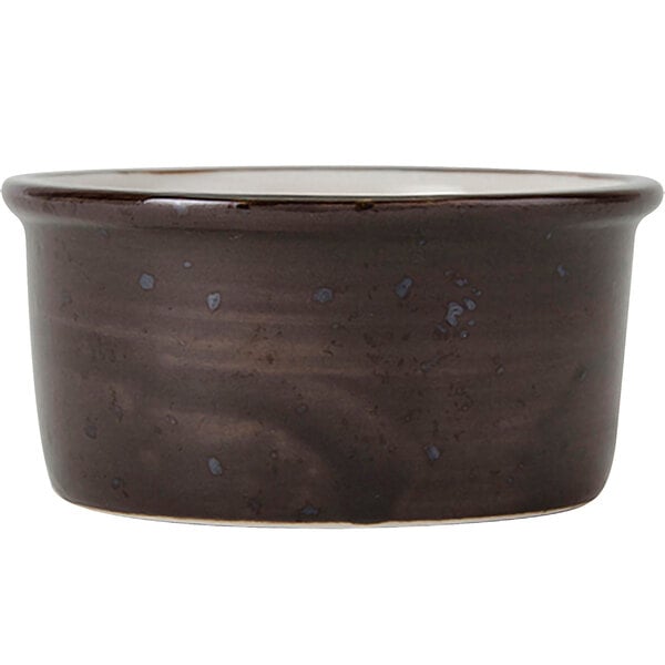 A brown ceramic Tuxton ramekin with a black rim.