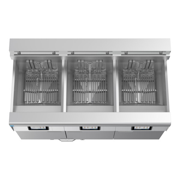A commercial electric floor fryer with three separate frypots and automatic filtration system.