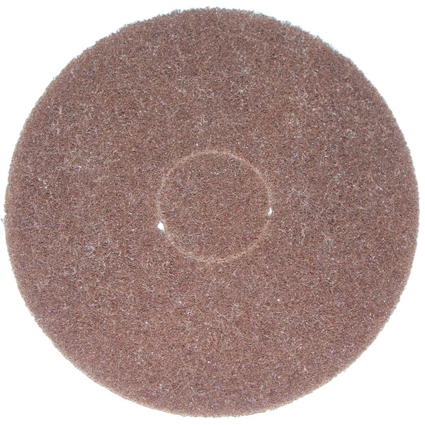 A brown circular Bissell scrubbing pad with a white circle in the middle.