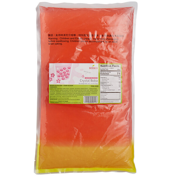A white bag of red liquid with a label for Bossen Cherry Blossom Crystal Boba syrup.