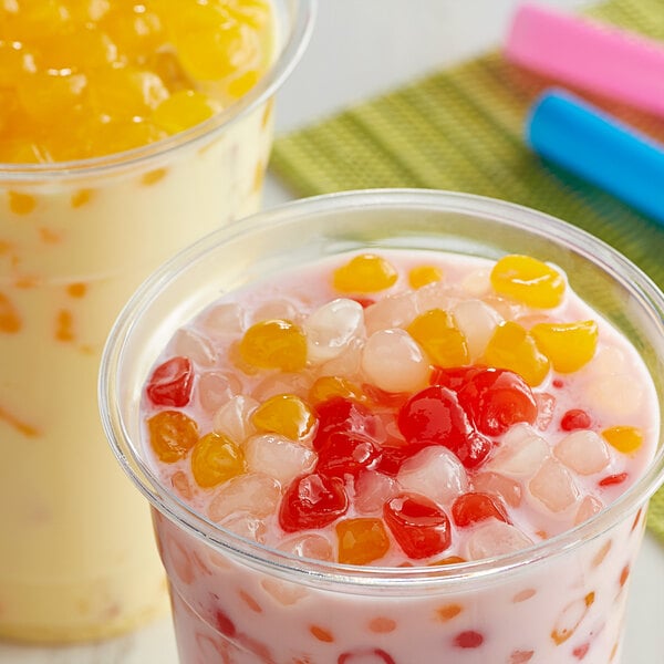 Two cups of food with colorful balls of Bossen Rainbow Crystal Boba in them.