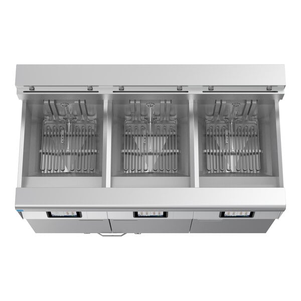 A commercial electric floor fryer with three separate frypots and automatic filtration system.