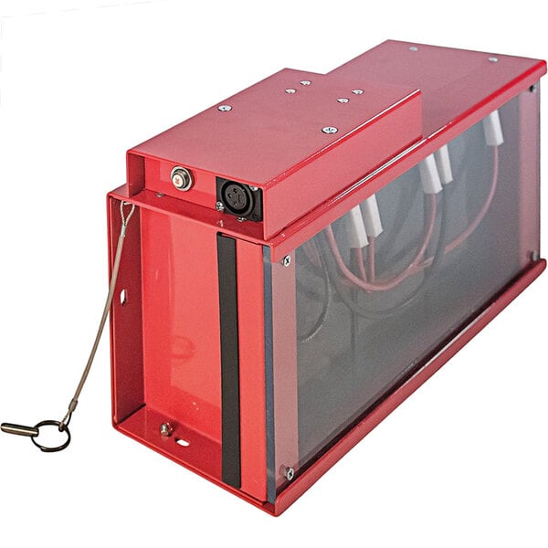 A red battery box with wires and a metal handle.