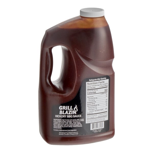 A large plastic jug of Grill Blazin' Hickory BBQ Sauce with a handle and nutrition label.
