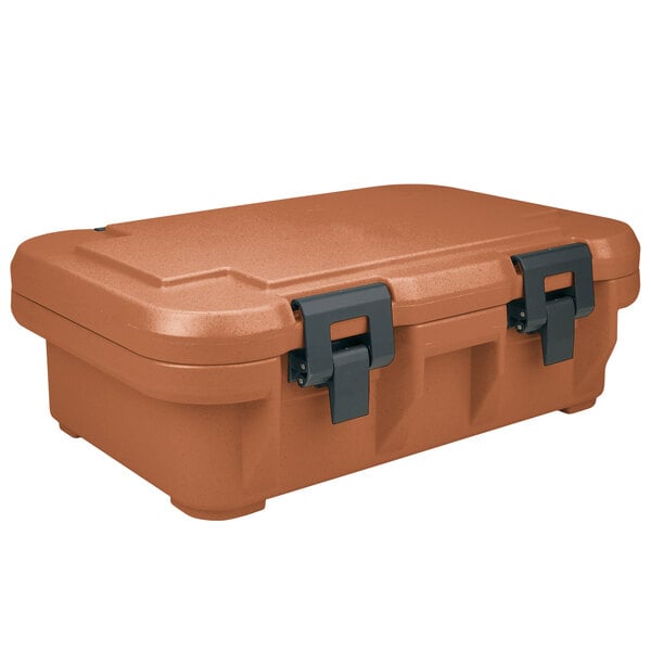 A brown plastic box with black handles containing a large orange plastic Cambro food pan carrier.