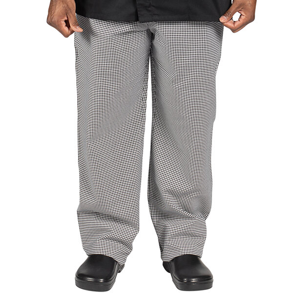 A person wearing Uncommon Chef houndstooth chef pants.