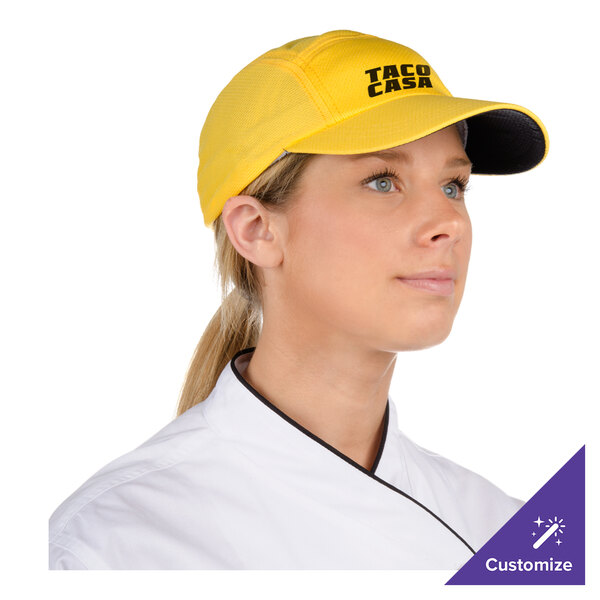 A woman in a chef uniform wearing a yellow Headsweats cap with a terry sweatband.