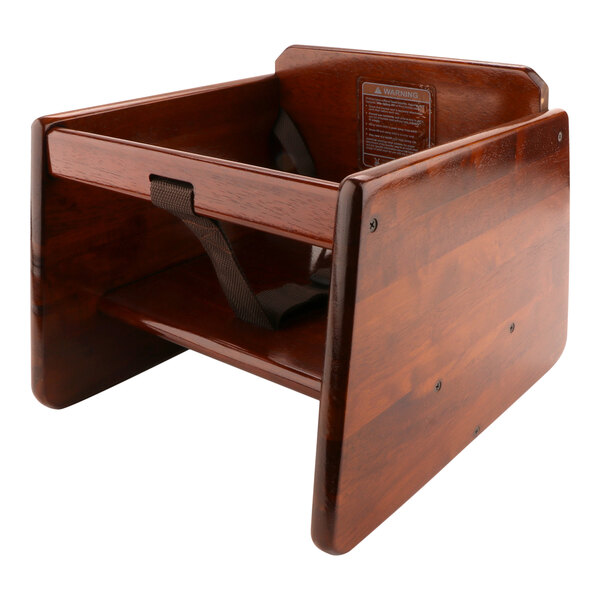 A walnut wood booster seat with a black strap.