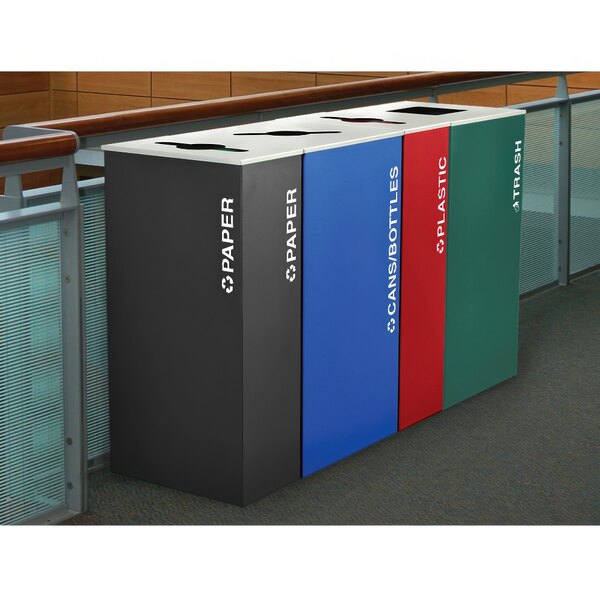 A group of different colored rectangular plastic recycle bins including red, blue, and black with white text.