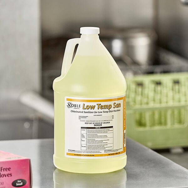 A jug of Noble Chemical Low Temp San concentrated dish washing machine sanitizer on a counter.