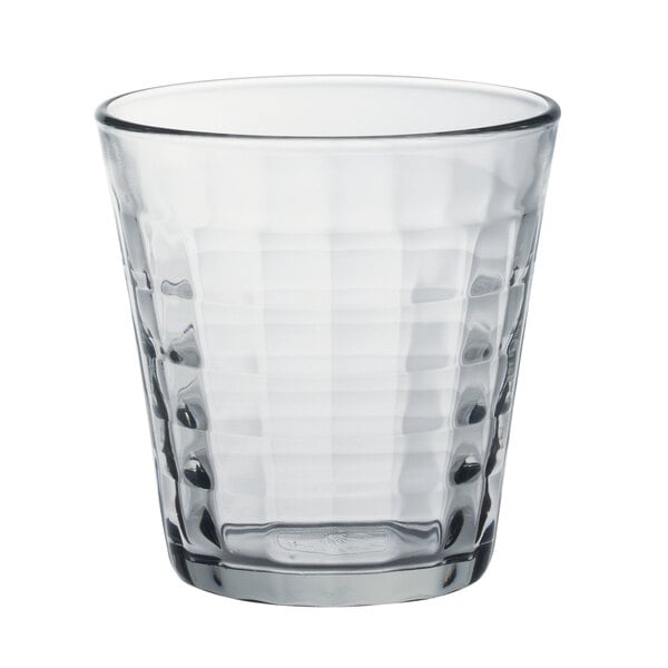 A clear Duralex glass tumbler with a checkered pattern.