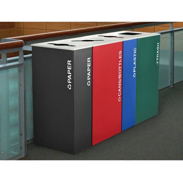 A row of rectangular Ex-Cell Kaiser Kaleidoscope XL plastic receptacles in different colors including blue, red, and black with white text.