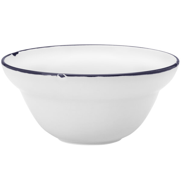 A white Luzerne porcelain cereal bowl with a blue rim.