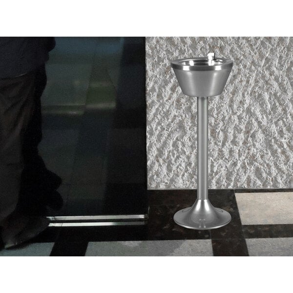 A chrome pedestal smoking urn.