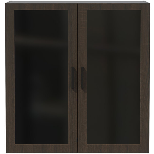 A Safco Mirella display cabinet in Southern Tobacco with glass doors and a dark wood frame.