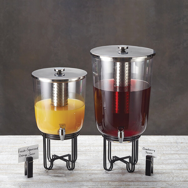 An American Metalcraft plastic beverage dispenser with orange juice in it.