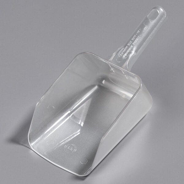 a plastic scoop on a white surface