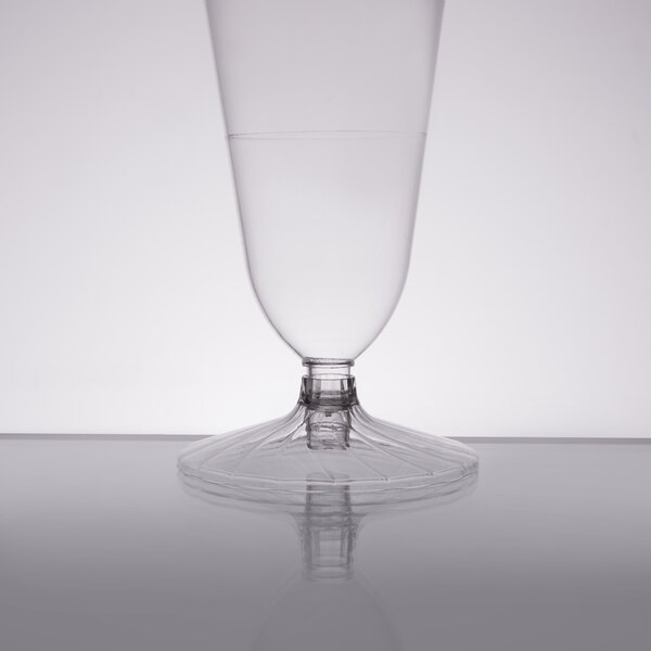 A clear plastic WNA Comet Pilsner cup with a clear liquid.