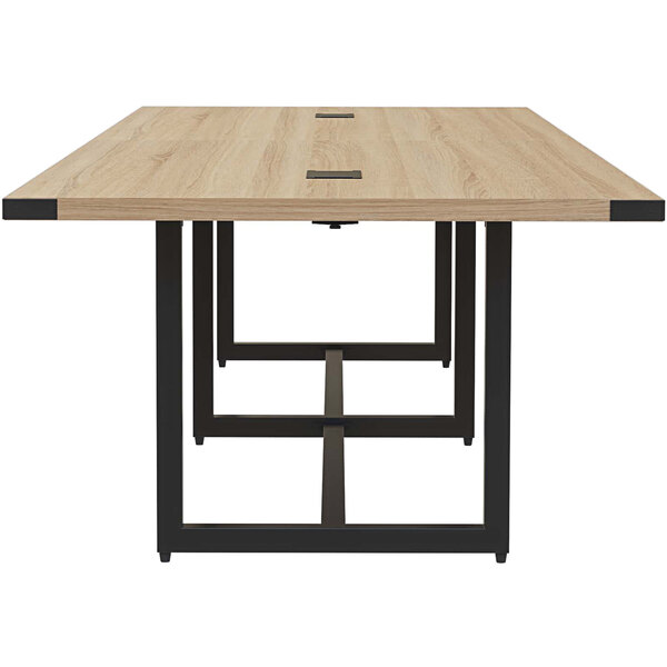 A Safco Mirella rectangular conference table with a wooden top and black legs.