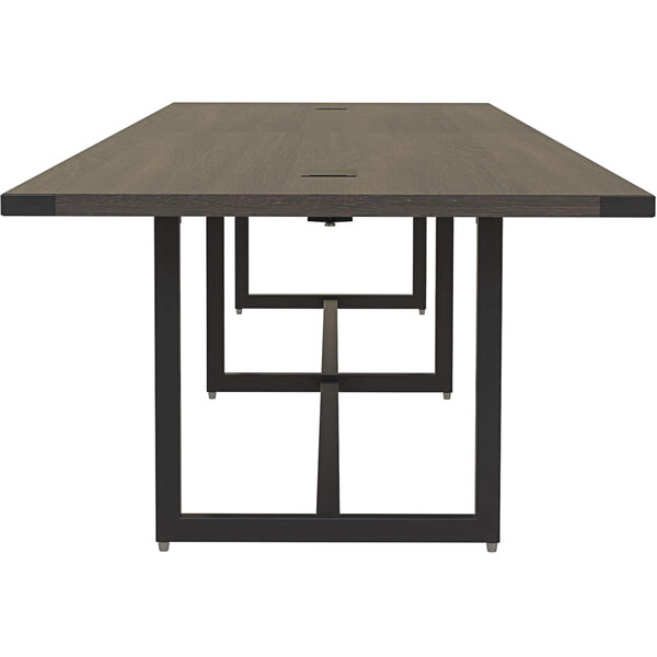 A Safco Mirella rectangular conference table with a wooden top and black legs.