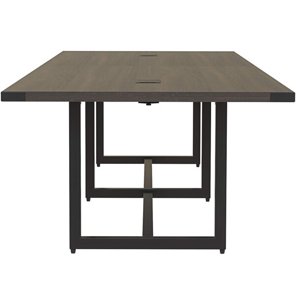A Safco Mirella rectangular conference table with black legs and a dark wood top.