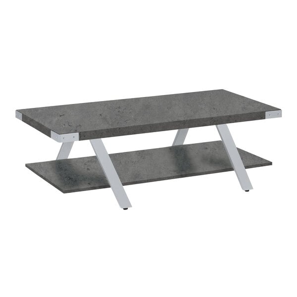 A Safco Mirella stone gray coffee table with white legs and two shelves.